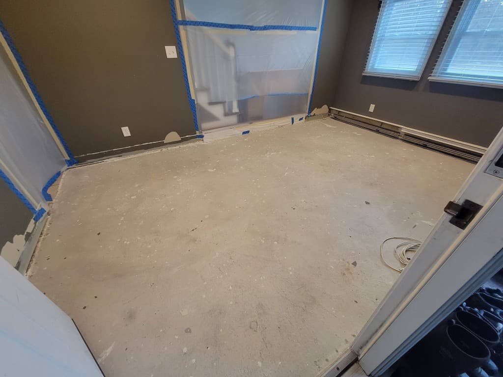 Interior room with bare prepped concrete floor before metallic epoxy coating