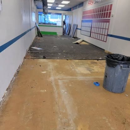 Commercial space with stripped flooring and debris before metallic epoxy